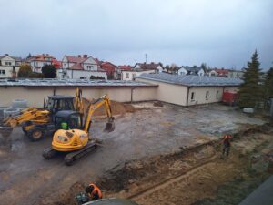 Plac budowy BCU, na placu maszyny budowlane pracownicy wykonujące prace ziemne