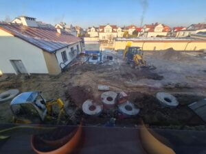 Plac budowy BCU, na placu maszyny budowlane pracownicy wykonujące prace ziemne