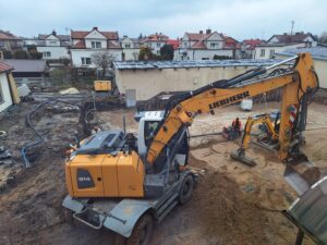 Plac budowy BCU, na placu maszyny budowlane pracownicy wykonujące prace ziemne