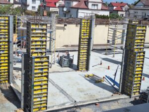 Plac budowy BCU. Pracujące maszyny pracownicy, Widać kolejny etap prac budowlanych (zalewanie filarów)